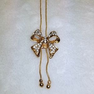 Gold bow tie adjustable choker necklace.
